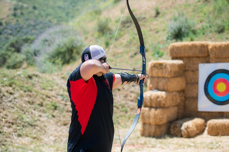 Close-up of a guy shooting with arrow